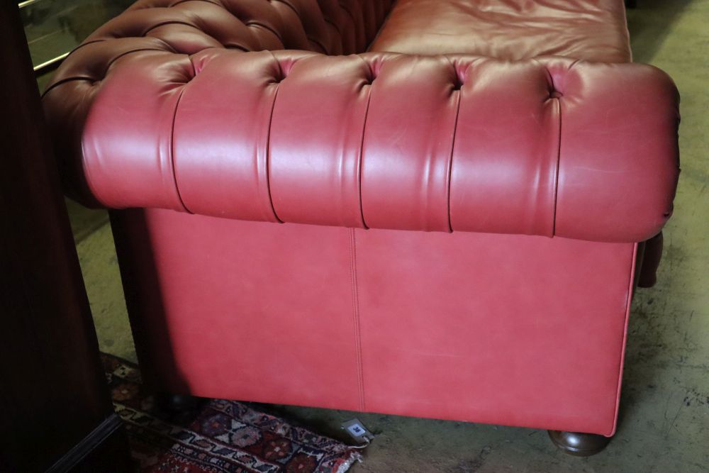 A Victorian style buttoned pale red leather Chesterfield settee, width 220cm depth 100cm height 74cm
